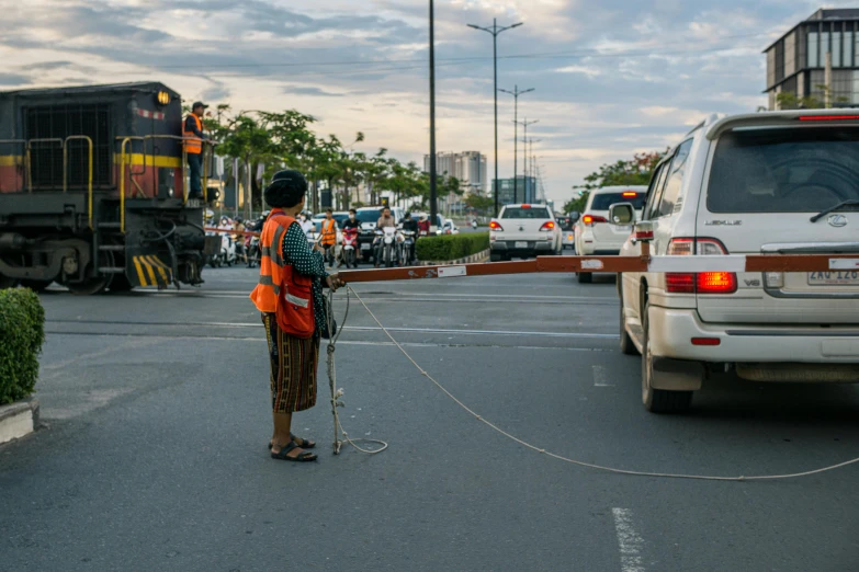 an asian man is holding a stick on the road