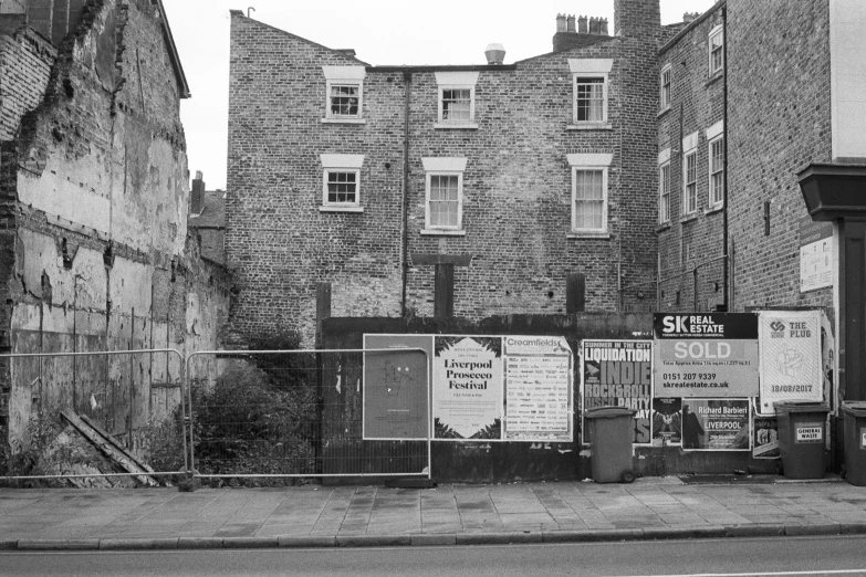 a brick building with several advertit boards next to it