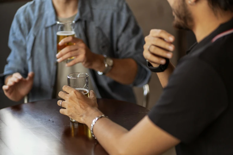 people sitting at a table with beers and beer