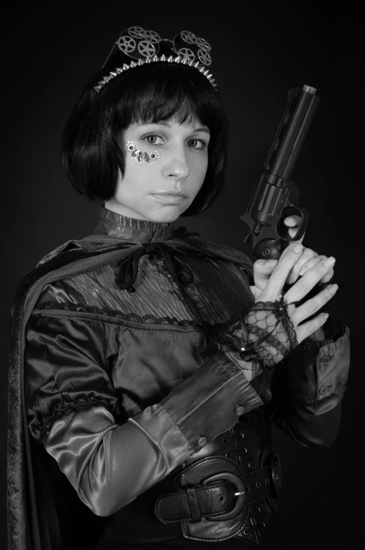 a woman dressed in costume holding a gun