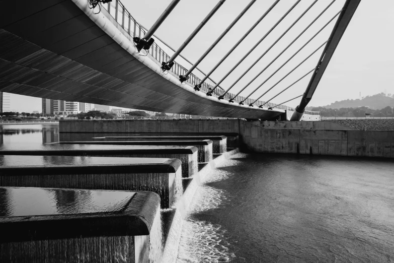 black and white pograph of bridge over water