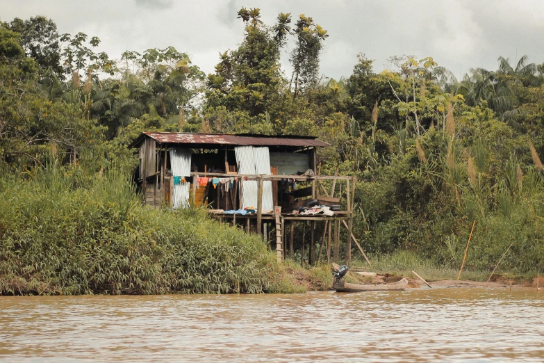 the house is sitting next to a river bank