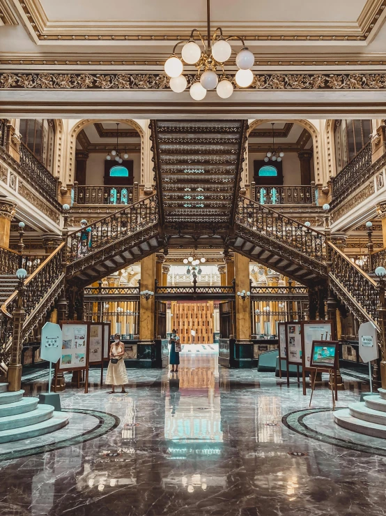 an elaborate building with several staircases and a marble floor