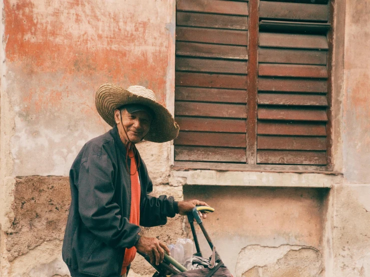 an old man walking down the street with a bag on his foot