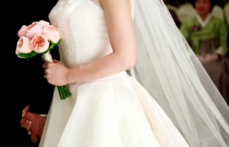 a bride holding her pink bouquet as they stand in front of some other men