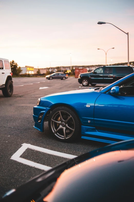 a blue car parked in a parking lot