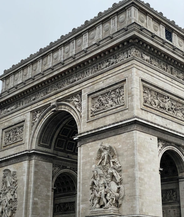 the stone arch features several statues on it