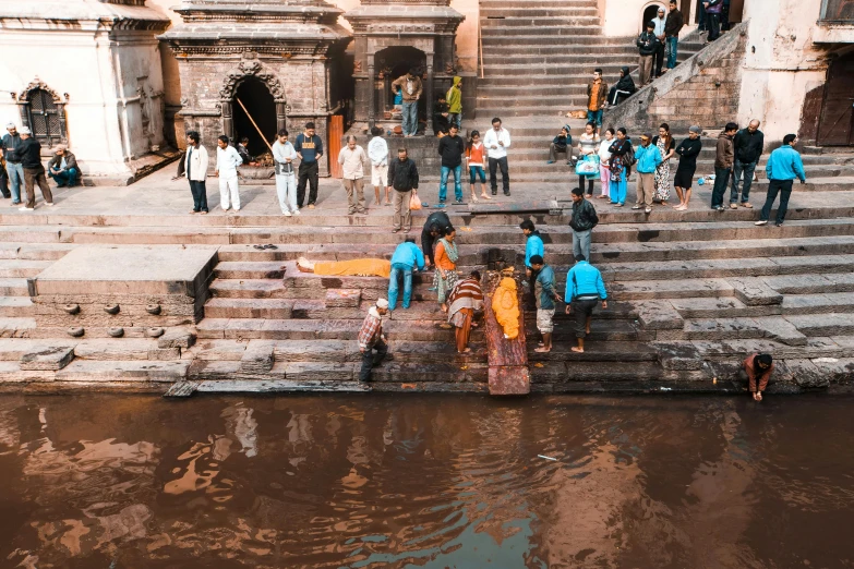 several people stand on the steps to their home