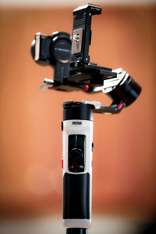 the back end of a tripod showing the control arm and its attachment