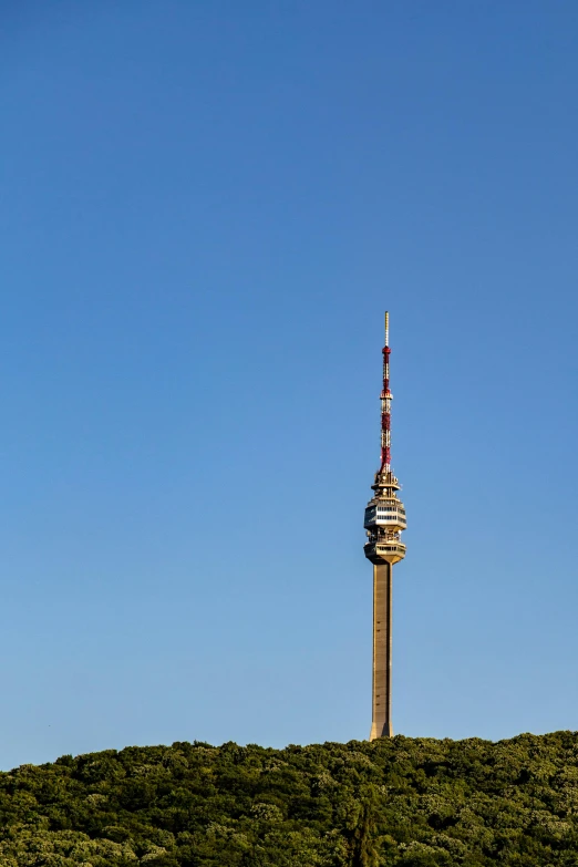 a view of a tall tower sitting on top of a hill