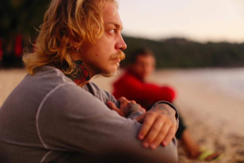 a couple of men that are standing up on the beach