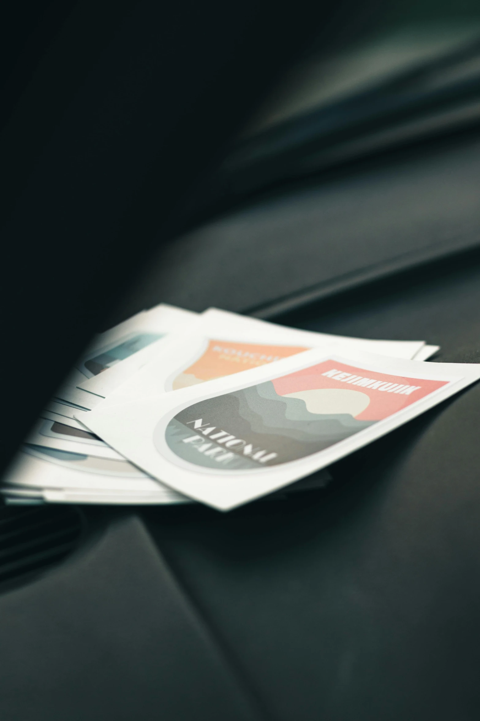 a lot of credit cards sit on top of a car hood