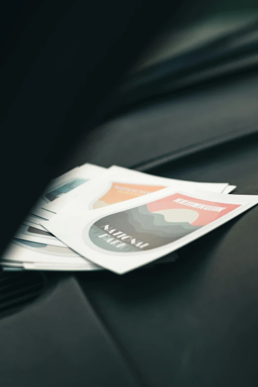 a lot of credit cards sit on top of a car hood