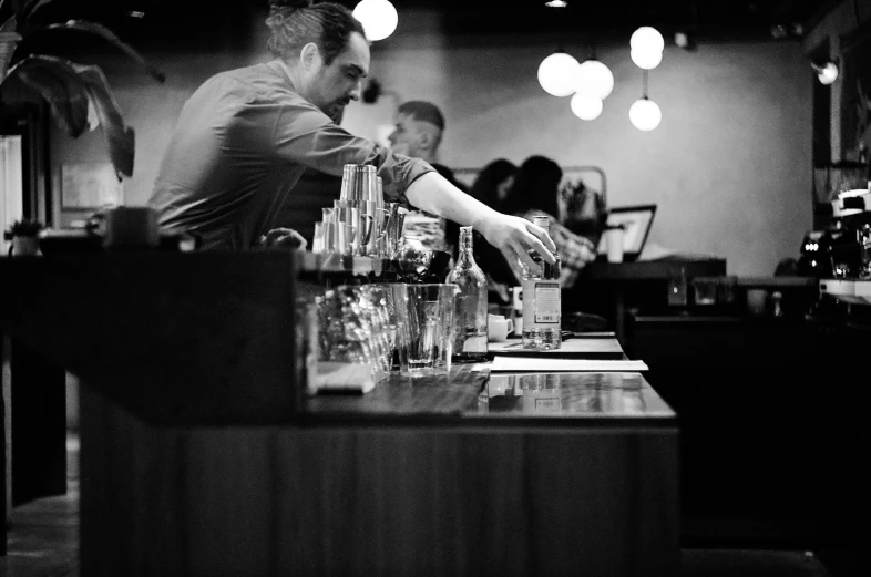 man making a drink in a bar