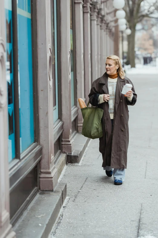 an old lady is walking by the corner of the street