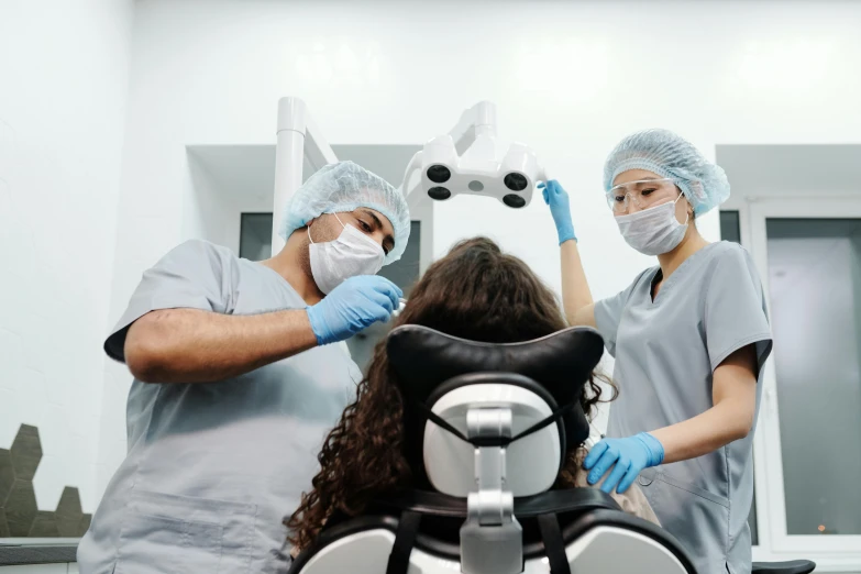 two doctors examine a patient's head inside a modern office