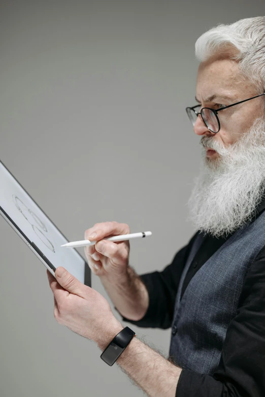 a bearded man holding an electronic device