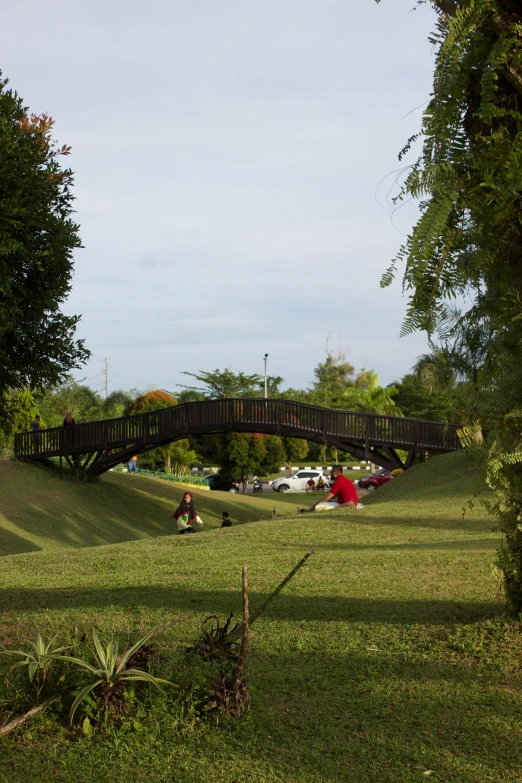 people playing with toys on an oval shaped ramp in the park