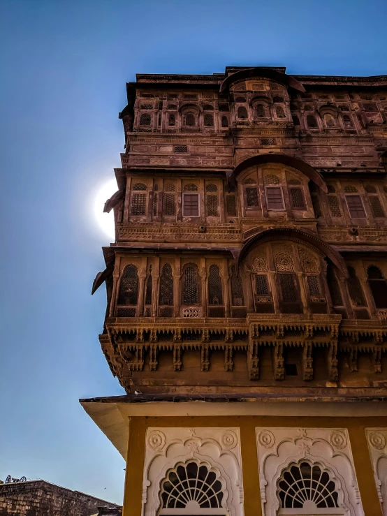 a large building is sitting below the sun