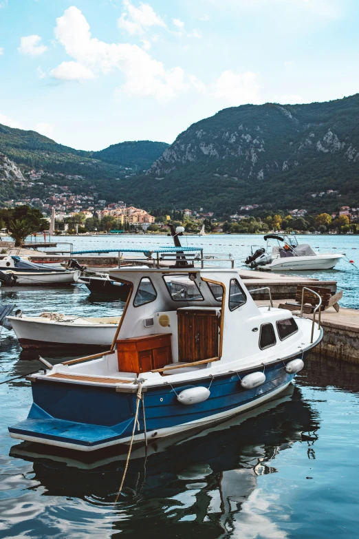 a small boat in the water near other boats