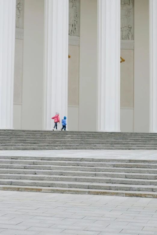 two blue umbrellas stand on a stone staircase