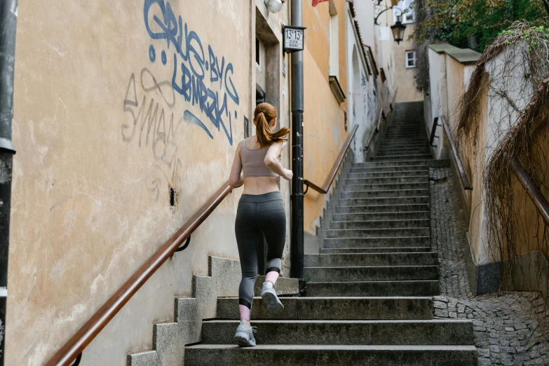 a woman is climbing stairs on the street