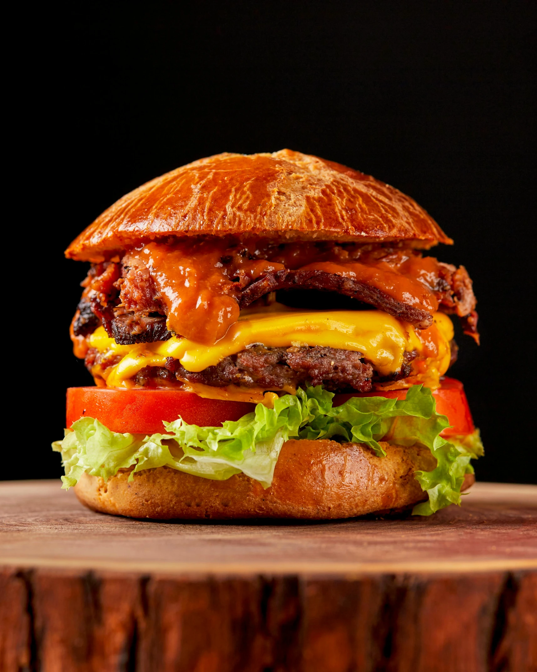 hamburger with meat and cheese on a wood block