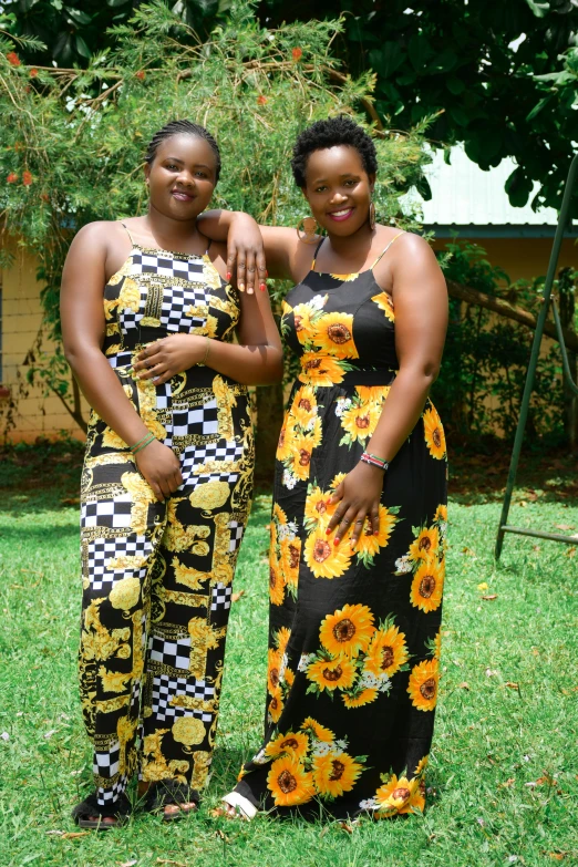 two women posing for a po in front of trees