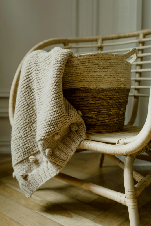 a small wicker basket sits next to some blankets