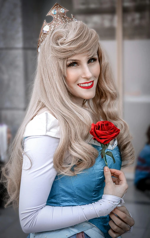 a woman in a princess costume poses for the camera