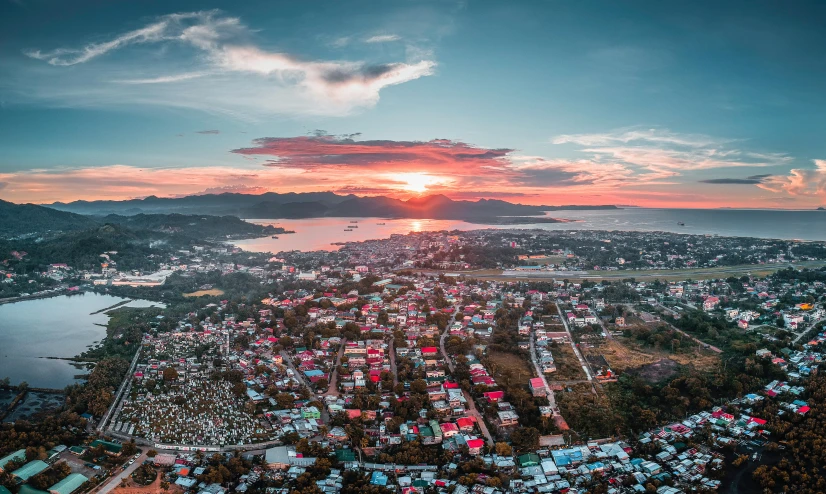 an aerial view of a city at sunset