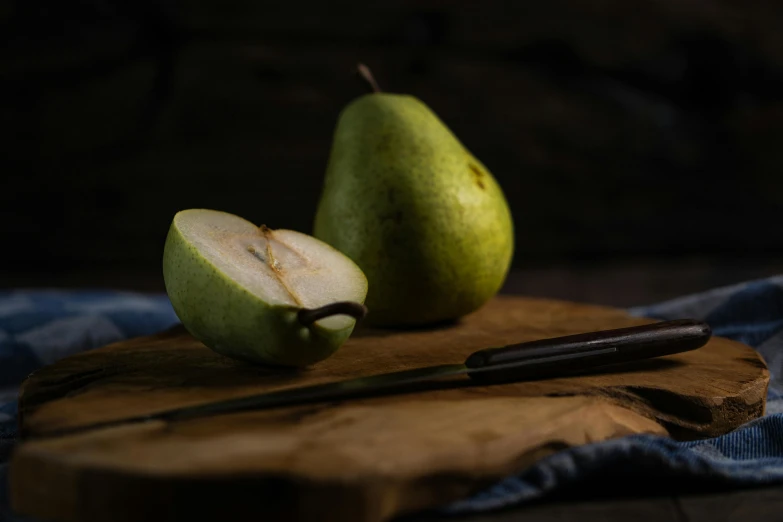 a  board with two pears sitting on it