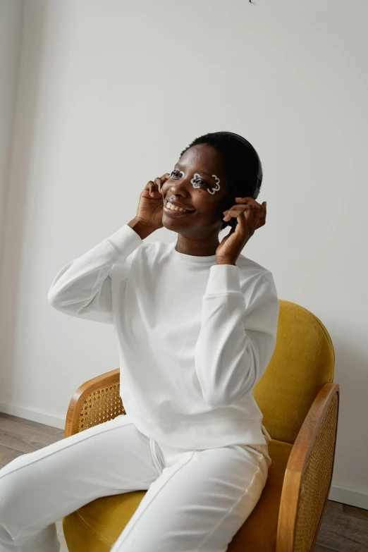 a person sitting on a chair talking on a cellphone