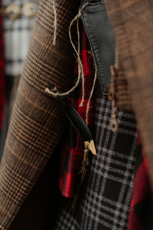 a close up of a piece of clothing with a brown coat hanging from it