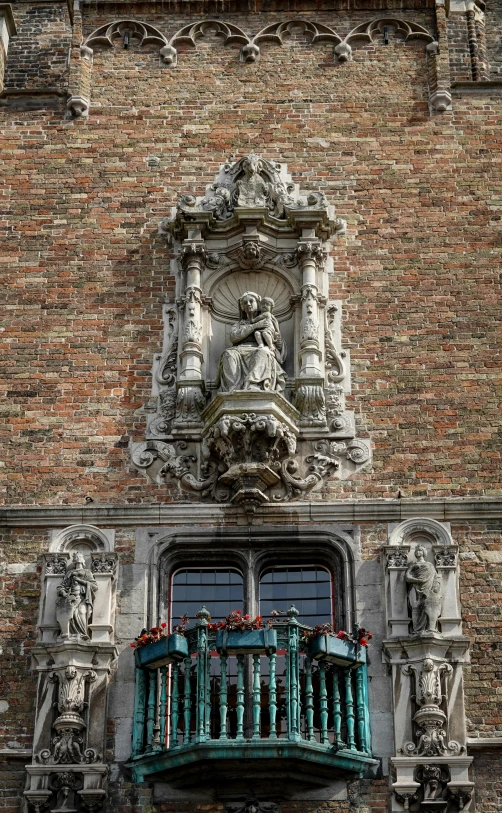 a window and a balcony on a brick building