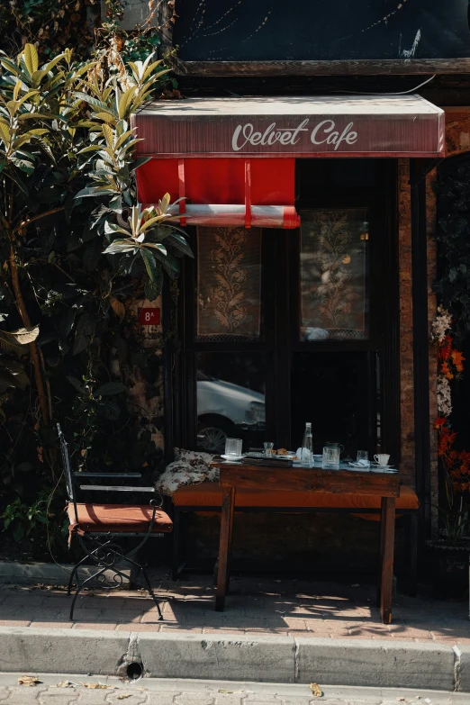 a wooden bench and chair outside a coffee shop