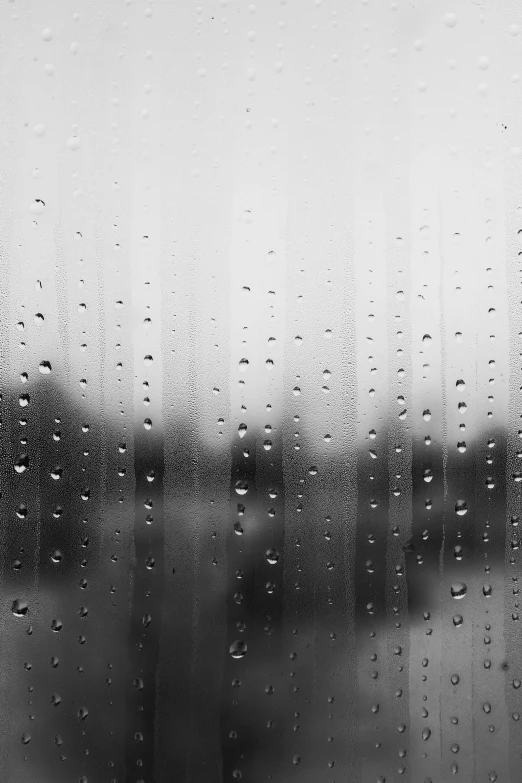 a window covered in water droplets on a rainy day