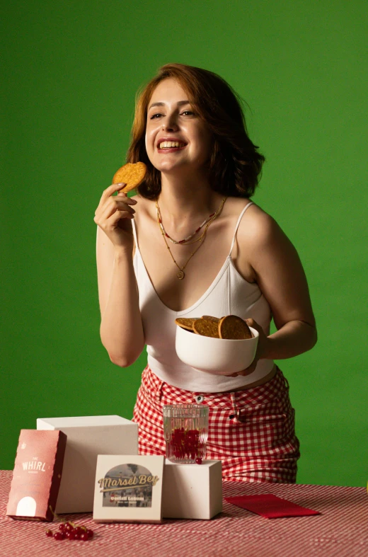 a woman is smiling and eating soing out of a bowl