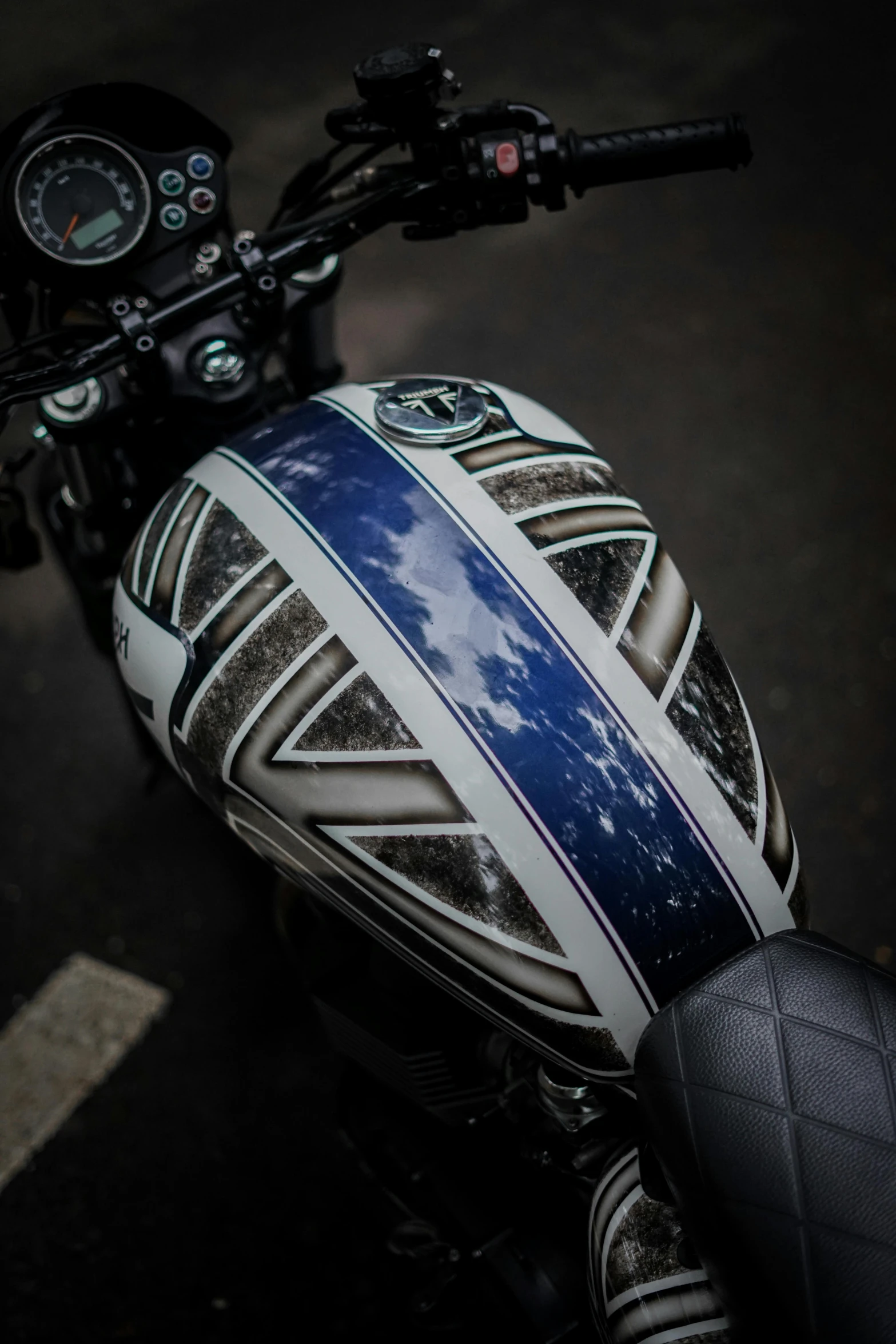 a motorcyclist's hand holding onto the seat of his bike