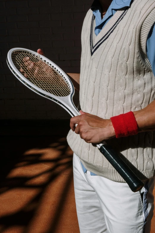 a man is posing for a po with his tennis racket