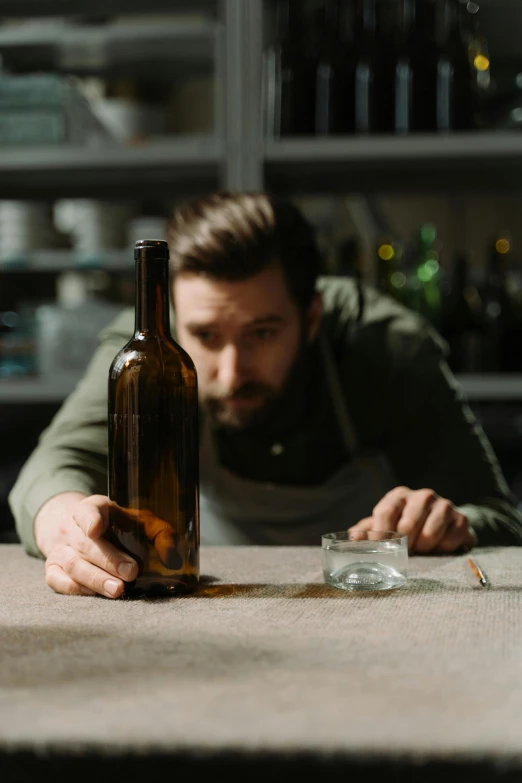 a man looking at his drink bottle