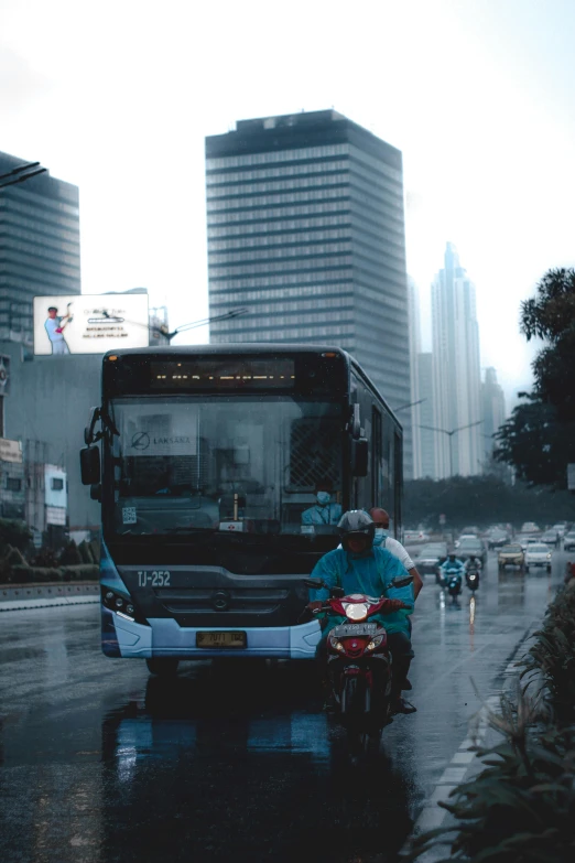 a city bus, driver on motorcycle and people walking in the rain