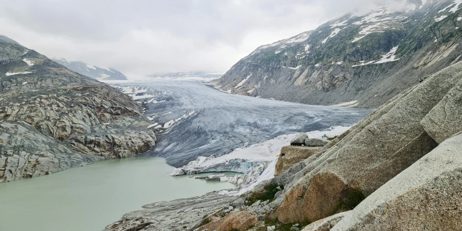 a lake surrounded by mountains and a glacier