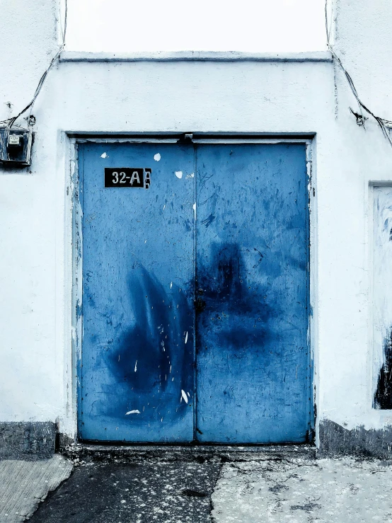the door is blue with an exit to a building
