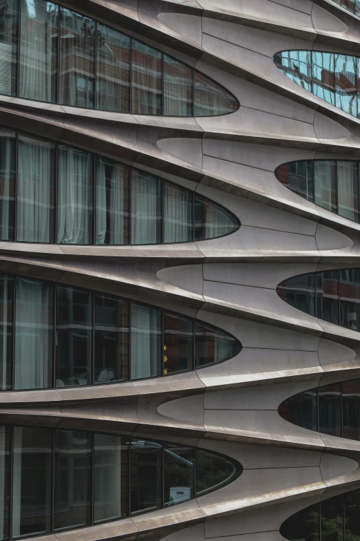 the side of an architectural building with multiple curves