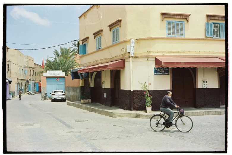 a man rides his bicycle on a quiet city street