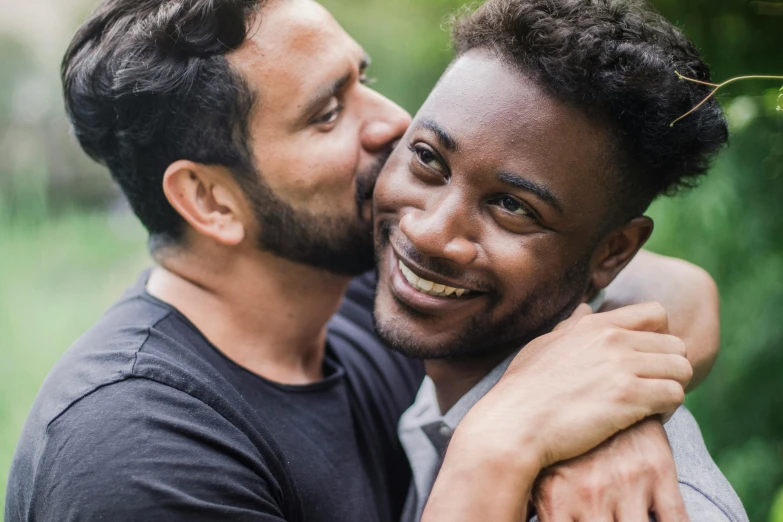 two men emcing each other with trees in the background