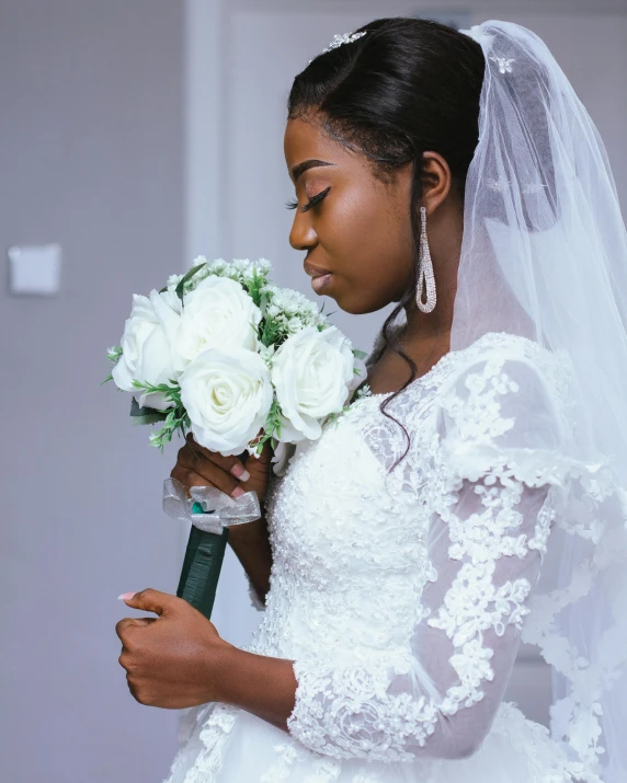 woman in wedding gown and flowers holding bouquet