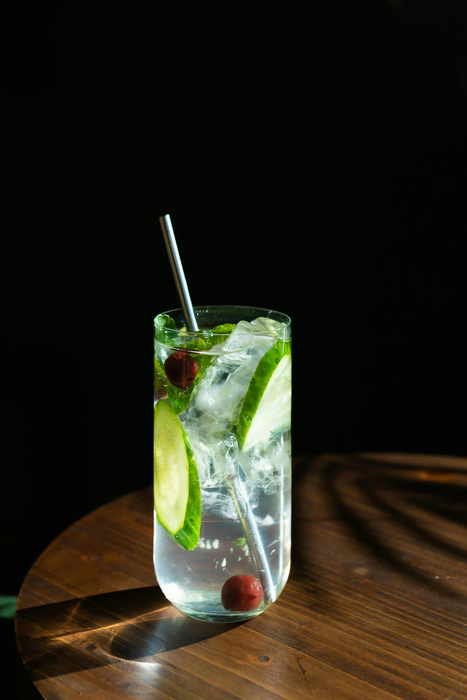 a glass with a drink on a wooden table