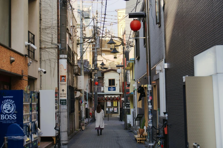 the narrow street is dotted with buildings and businesses